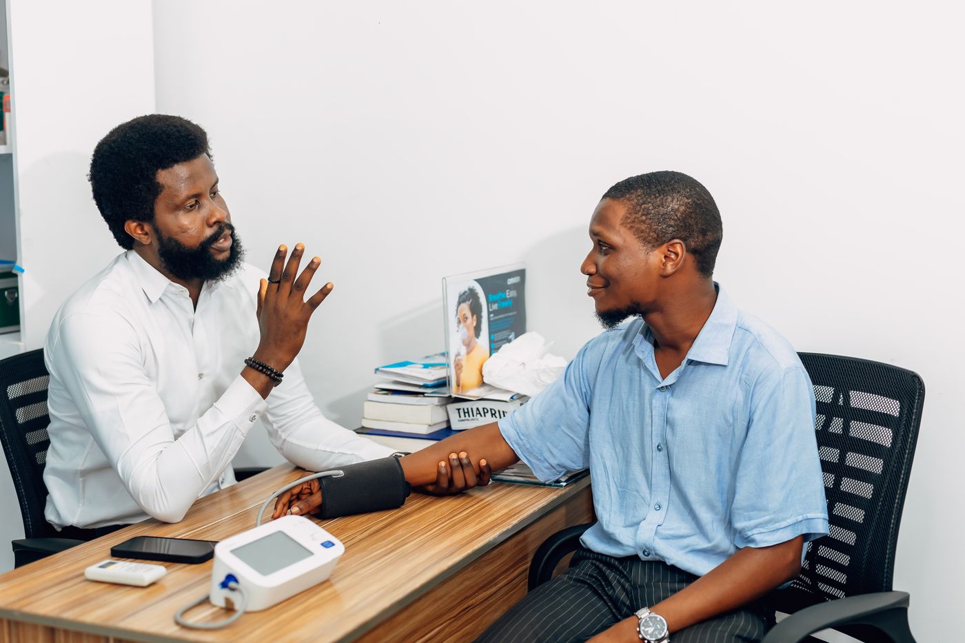 Cardiologist consulting a patient at his desk