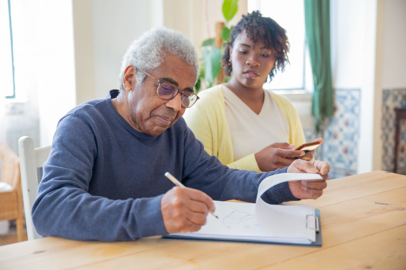 Elderly patient reviewing his care plan with a carer