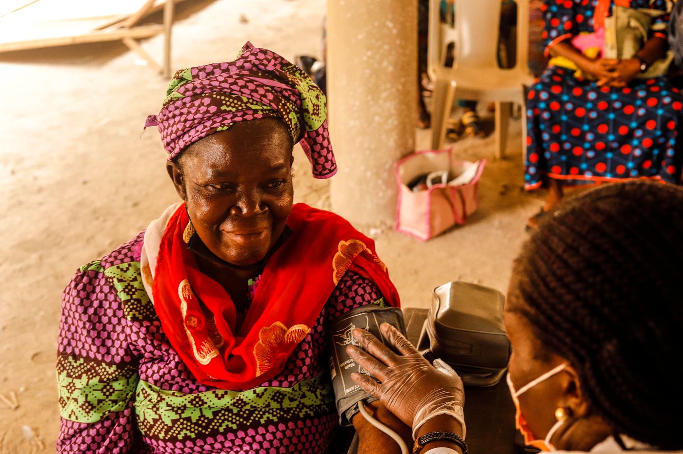 Nurse checking an elderly woman's blood pressure
