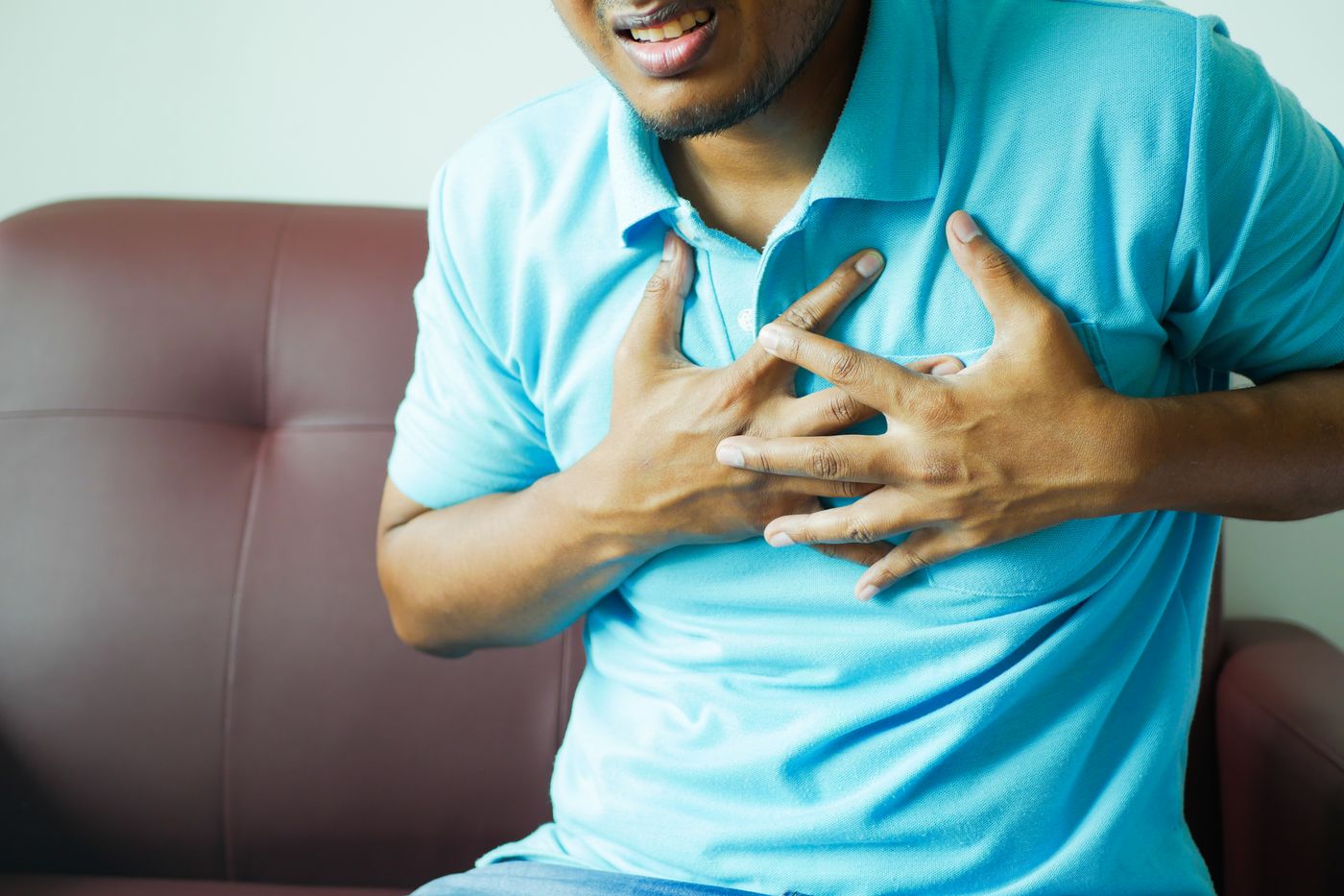 Man holding his chest in discomfort
